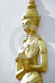 Golden monk statue press the hands together at the chest or fore