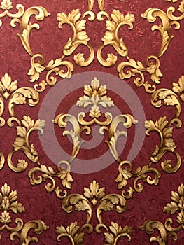 Golden monograms on a dark red background