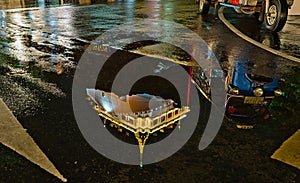 Golden Mount reflection in a puddle and a Tuk Tuk