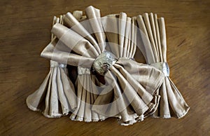 Golden napkin bow with silver ring fancy folding for holiday