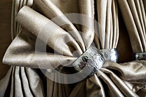 Golden napkin bow with silver ring fancy folding for holiday