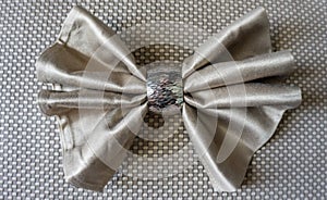 Golden napkin bow with silver ring fancy folding for holiday