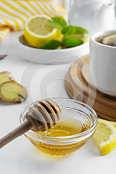 Golden natural honey autumn winter hot drink ingredient glass bowl honey spoon seasonal