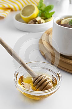 Golden natural honey autumn winter hot drink ingredient glass bowl honey spoon seasonal