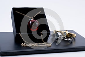 Golden necklace in a box and two beautiful watches