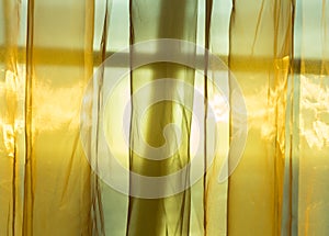 Golden net curtains shield sunshine behind window