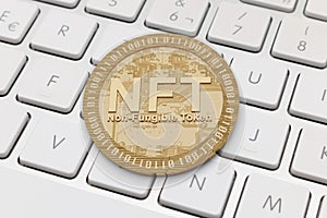 Golden NFT on white keyboard. Non fungible token