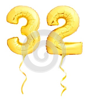 Golden number 31 thirty two made of inflatable balloon with ribbon on white