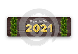 Golden numbers 2021 on wood background. Holiday gift card Happy New Year with fir tree branches garland. Celebration