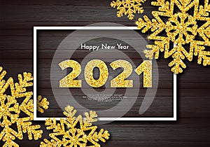 Golden numbers 2021 on wood background. Holiday gift card Happy New Year with gold sparkling snowflakes. Celebration