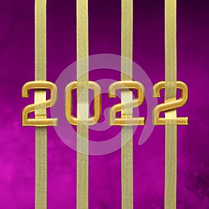 Golden numbers 2022 with ribbons on velvet violet background.