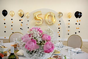 Golden numbers 50 on the wall of the banquet hall.