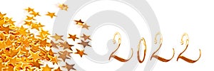 Golden numbers 2022 with christmas table ornaments on white panoramic background new year web banner