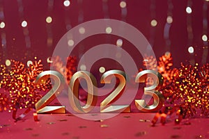 Golden numbers of year 2023. Glowing festive garland with bokeh on red background.