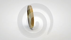 Golden nxt coin spinning on table white background