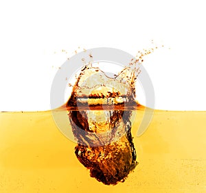 Golden oily liquid splash on white background