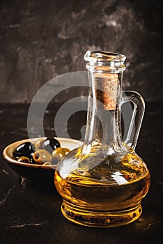 Golden olive oil with olives