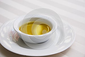 Golden Olive Oil on White Tablecloth