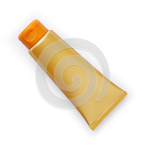 Golden and orange sunscreen tube solar cream isolated in white background photo