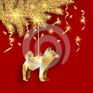 Golden origami dog as a Christmas decoration for a golden Christmas tree branch.