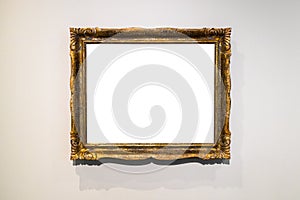 Golden ornamental picture frame on gray brown wall