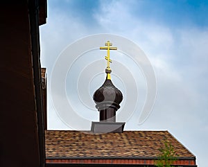 Golden Orthodox cross on the dome of the cathedral