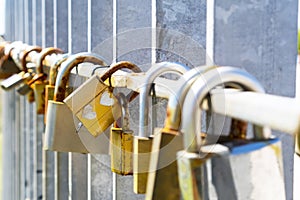 Golden padlock with a couple of hearts scrawled. A pair of rusty old coupled locks