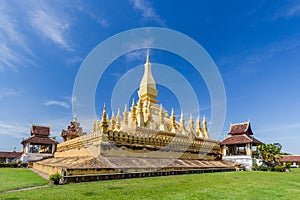 Golden pagada in Pha-That Luang tample on blue sky background