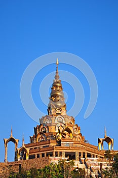Golden pagoda in the blue sky background photo