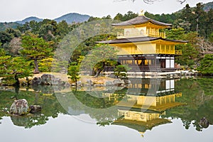 Golden pagoda and reflection on lake in autumn at Kinkakuji Temp