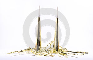 Golden painted party whistles on a white background