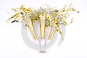 Golden painted three party whistles on a white background