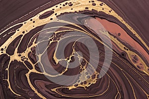 Golden pattern on brown waves and curls. Acrylic Fluid Art. Abstract background or texture