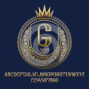 Golden patterned letters and numbers with coat of arms template with crown. Awesome font and elements kit for logo design