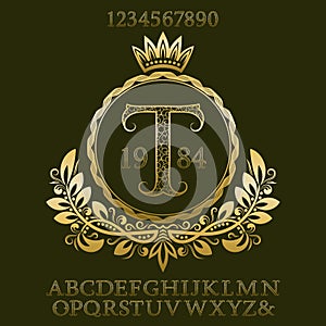 Golden patterned letters and numbers with initial monogram in coat of arms form. Elegant font and elements kit for logo