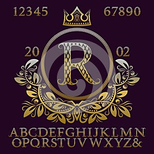 Golden patterned letters and numbers with initial monogram in coat of arms form. Elegant font and elements kit for logo