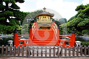 Golden pavilion with red bridge in Chinese garden