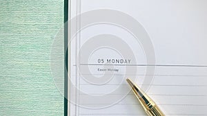 The golden pen points to `Easter Monday` in the diary.