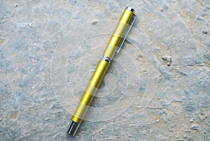 Golden Pen on textual background