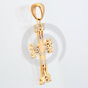 Golden pendant cross with red light stone panorama