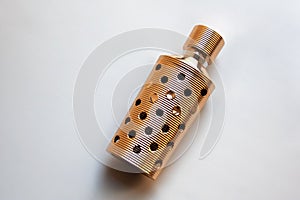 Golden perfume bottle case with honeycomb pattern