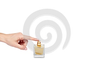 Golden perfume bottle with hand isolated on white background, copy space template