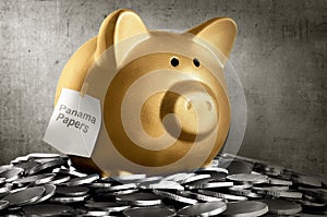 Golden piggybank with panama papers text