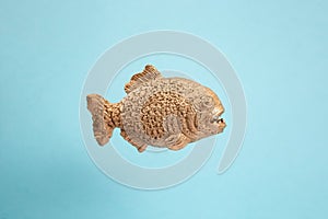 Golden piranha fish on blue background, abstract textures