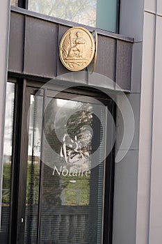 Golden plate notary in wall building office for french Notaire photo