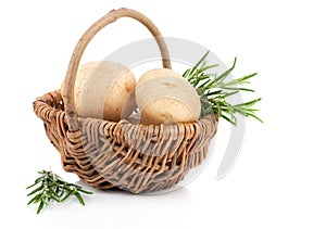 Golden Potatoes in wicker basket, with rosemary