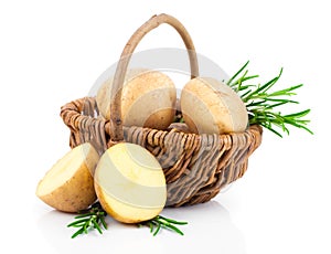 Golden Potatoes in wicker basket with rosemary