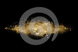 Golden powder explosion on black background.