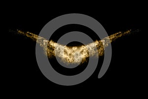 Golden powder explosion on black background