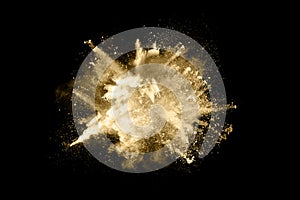 Golden powder explosion on black background